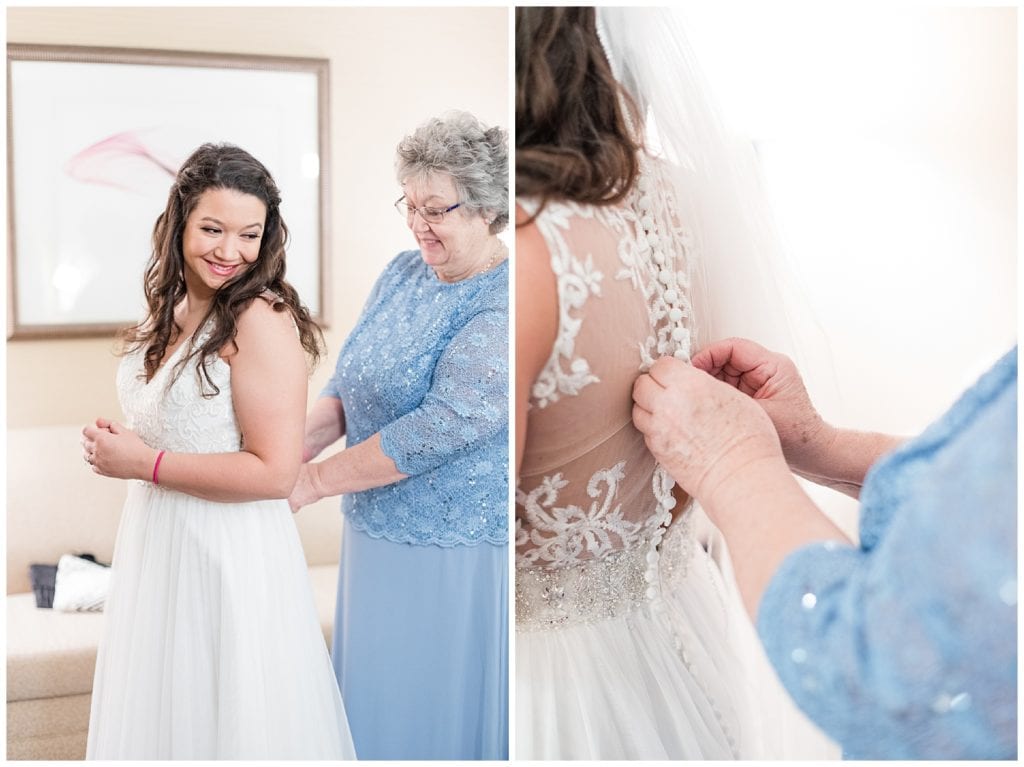 Bride putting dress on with mother at Country Inn & Suites by Radisson.