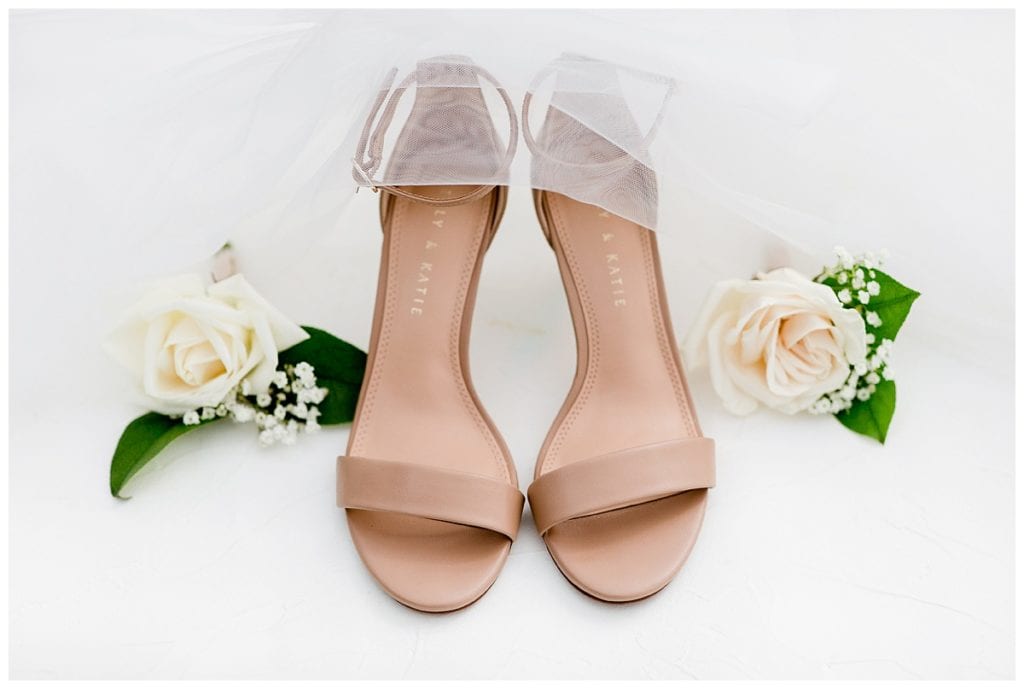 Brides wedding shoes and flowers for Downtown Market wedding.