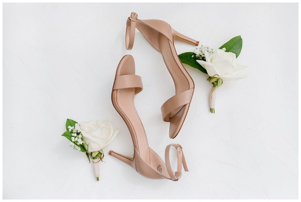 Brides beige wedding shoes with white rose boutonnieres at the Downtown Market wedding.