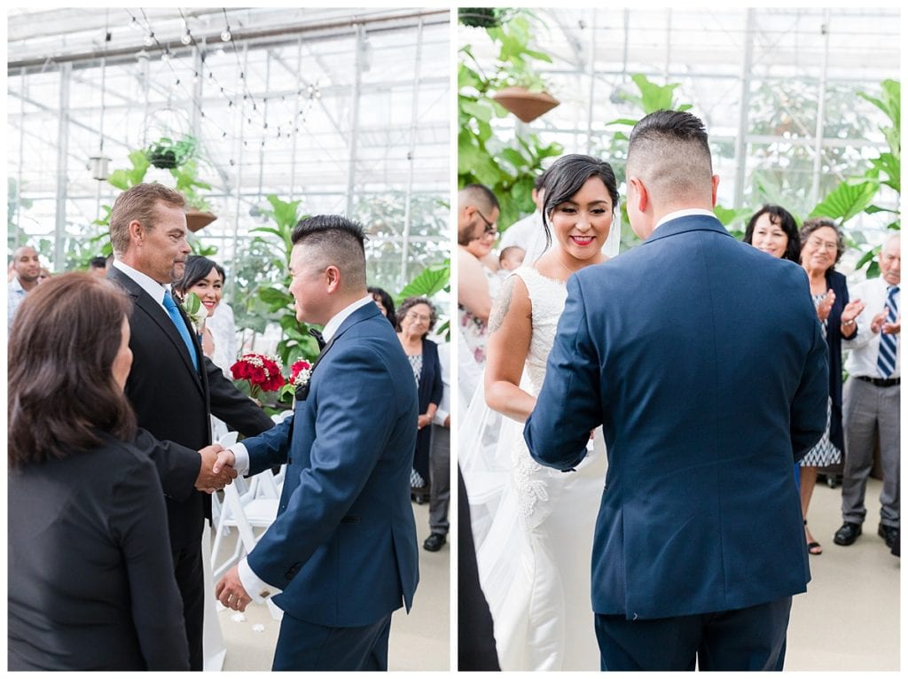 Groom shaking bride's father's hand during wedding ceremony at Downtown Market Grand Rapids.