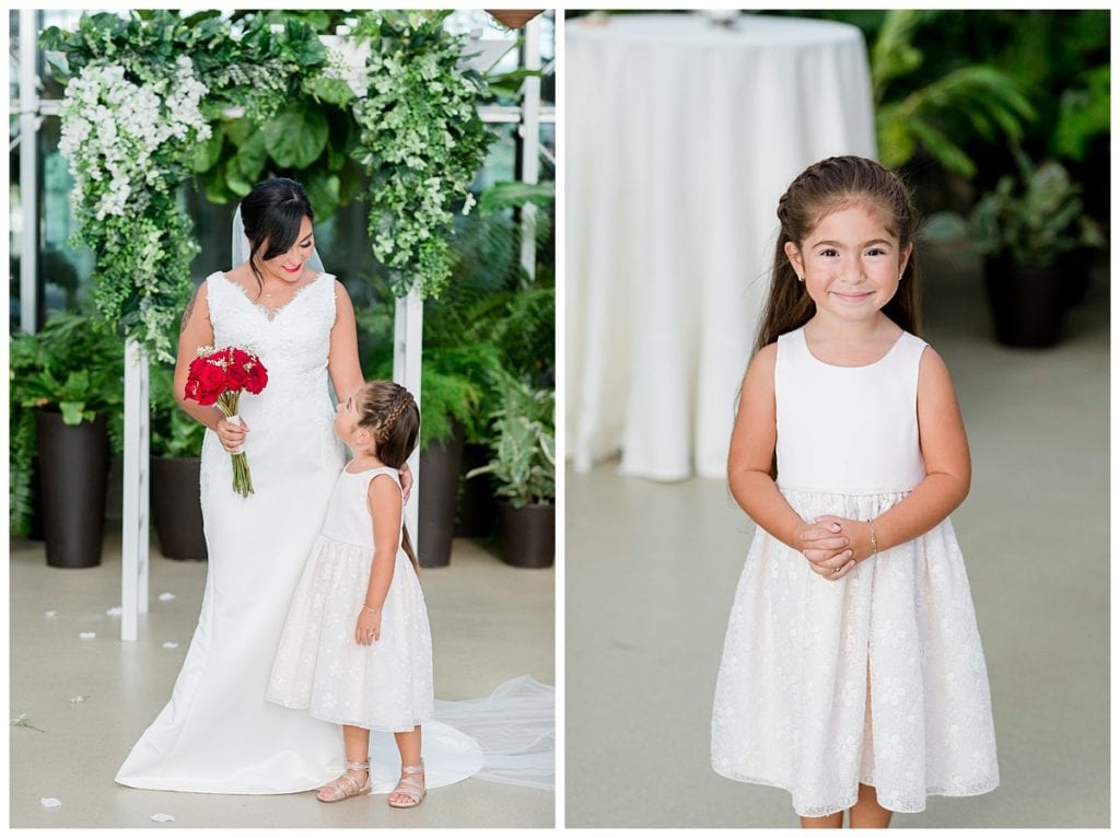 Bride with flower girl smiling for pictures at Downtown Market wedding.