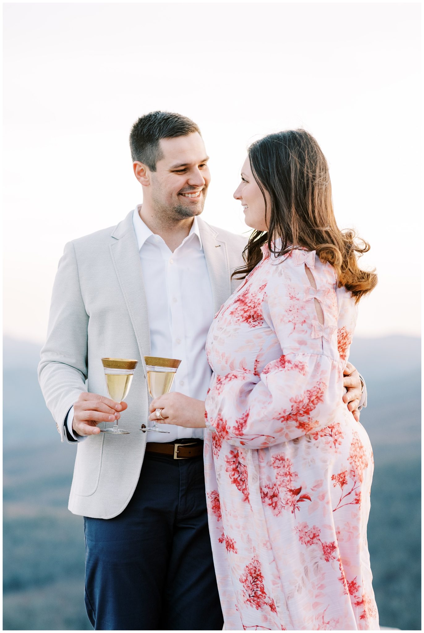 Popping champagne during engagement photos
